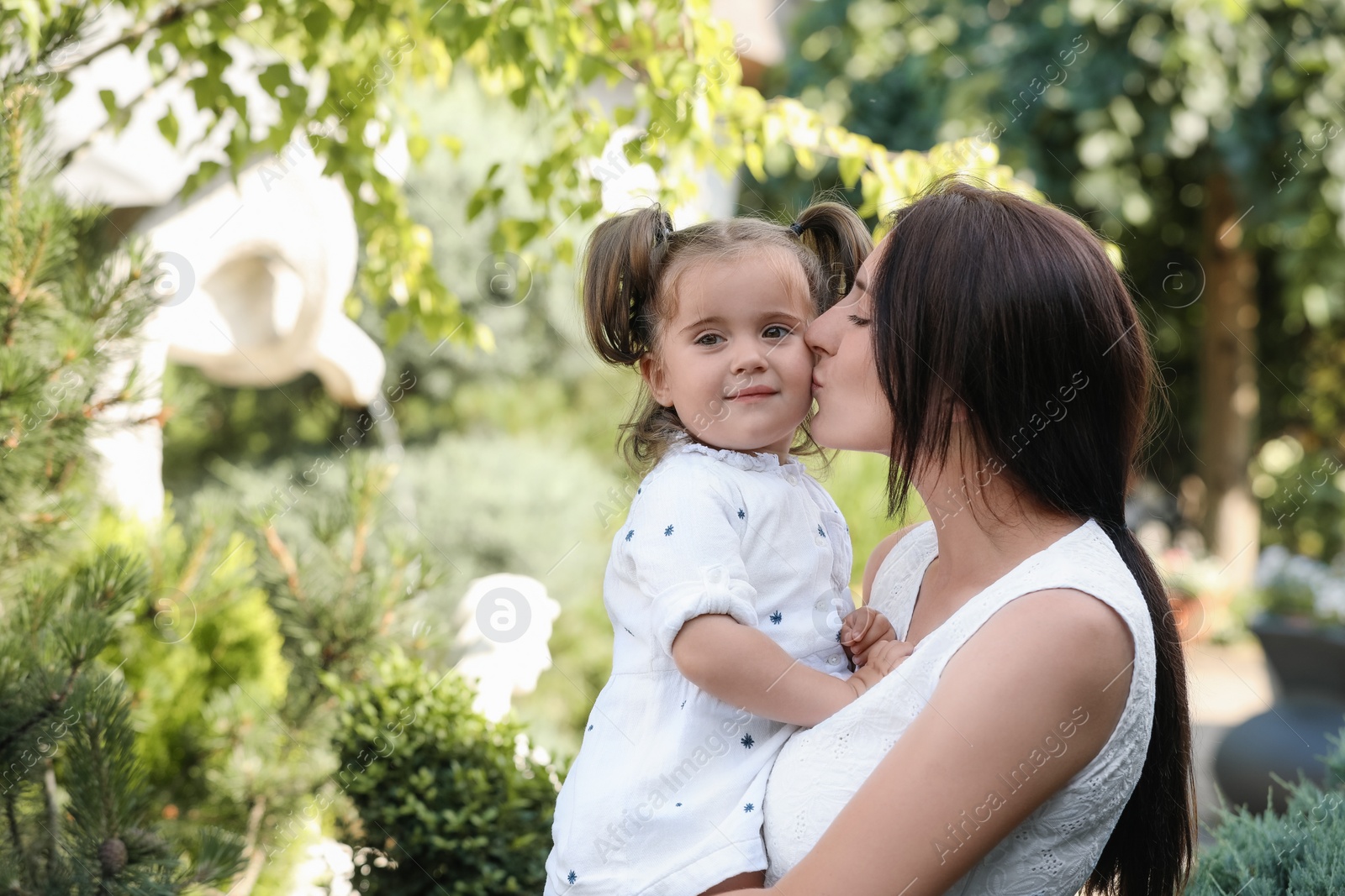 Photo of Happy mother with her cute daughter spending time together in park