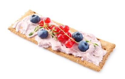 Photo of Tasty crispy cracker with cream cheese, thyme and berries isolated on white