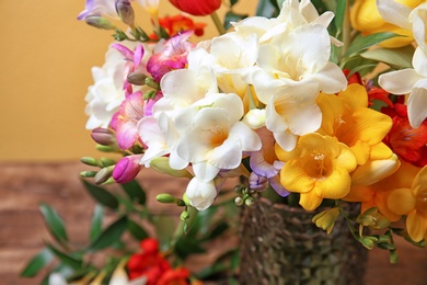 Vase with beautiful freesia flowers, closeup