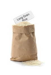 Paper bag with uncooked long grain rice and card on white background