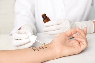 Photo of Doctor making allergy test at table, closeup