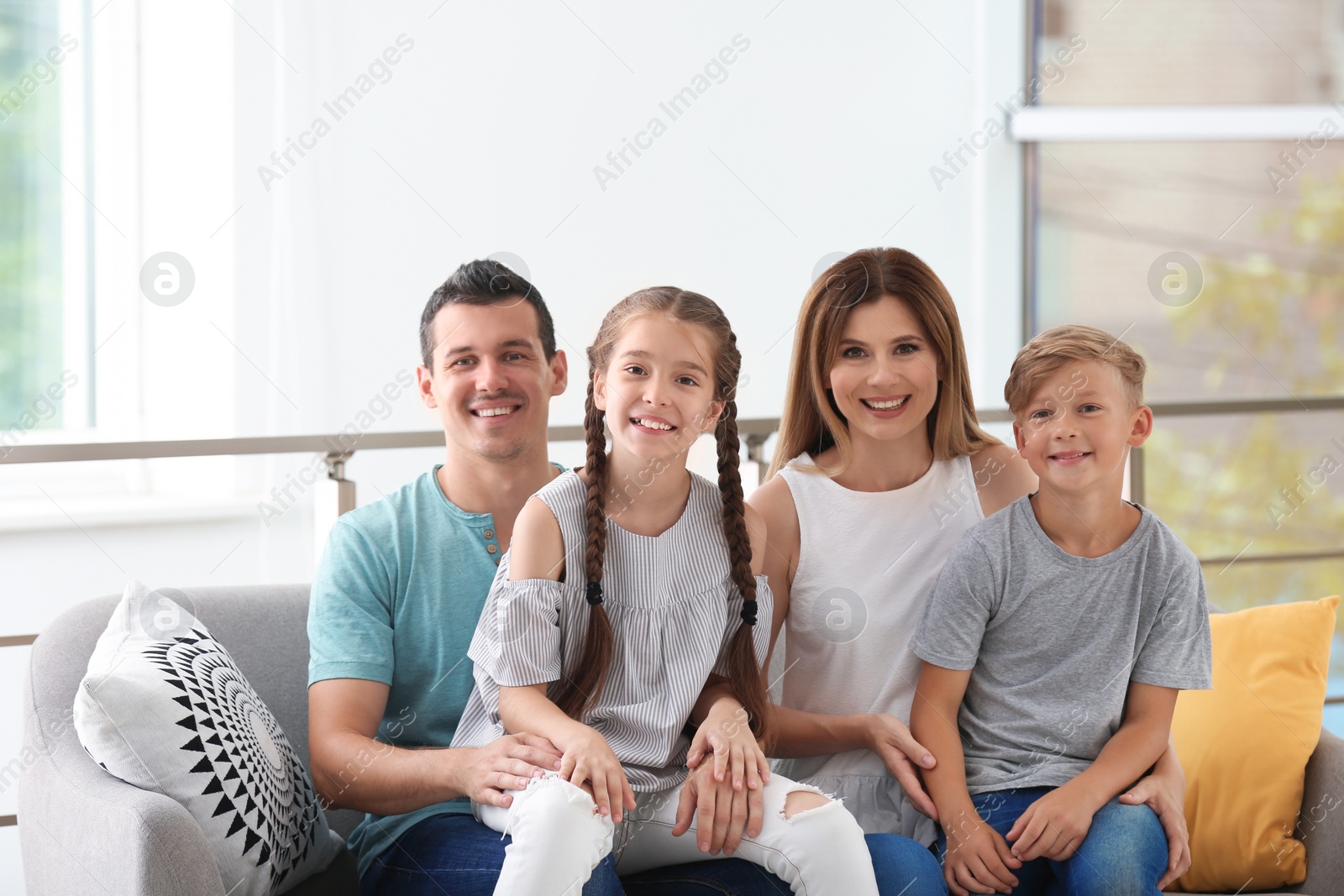 Photo of Happy family with cute children at home