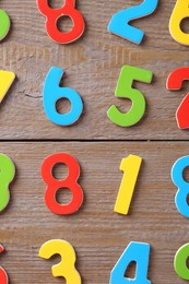 Colorful numbers on wooden table, flat lay