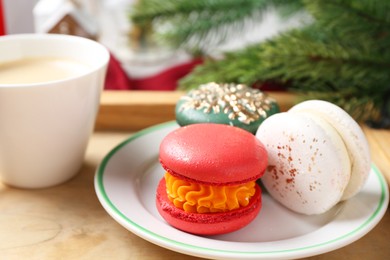 Different decorated Christmas macarons on table, closeup