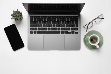 Photo of Modern laptop, smartphone and cup of coffee on white table, flat lay. Space for text