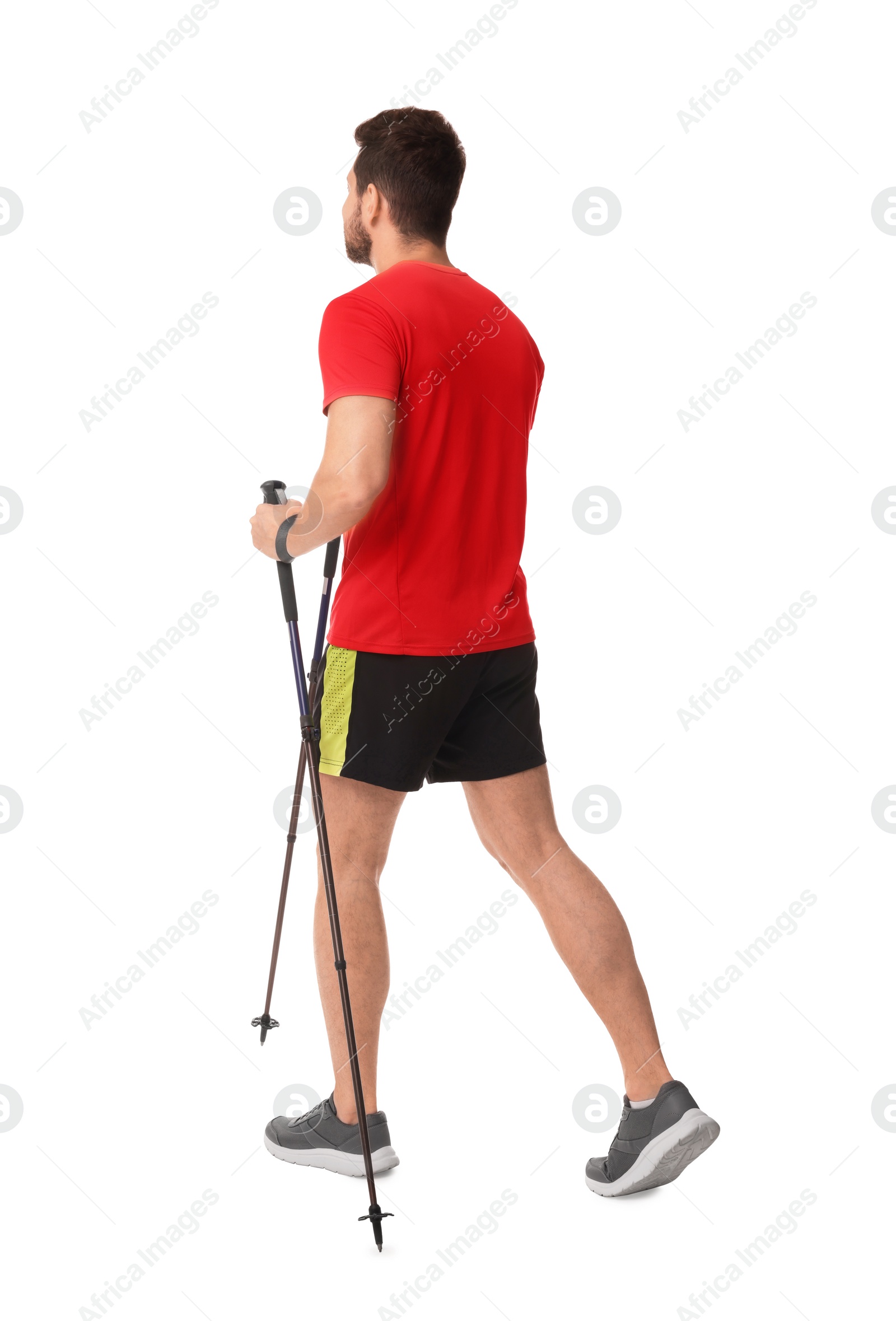 Photo of Man practicing Nordic walking with poles isolated on white, back view