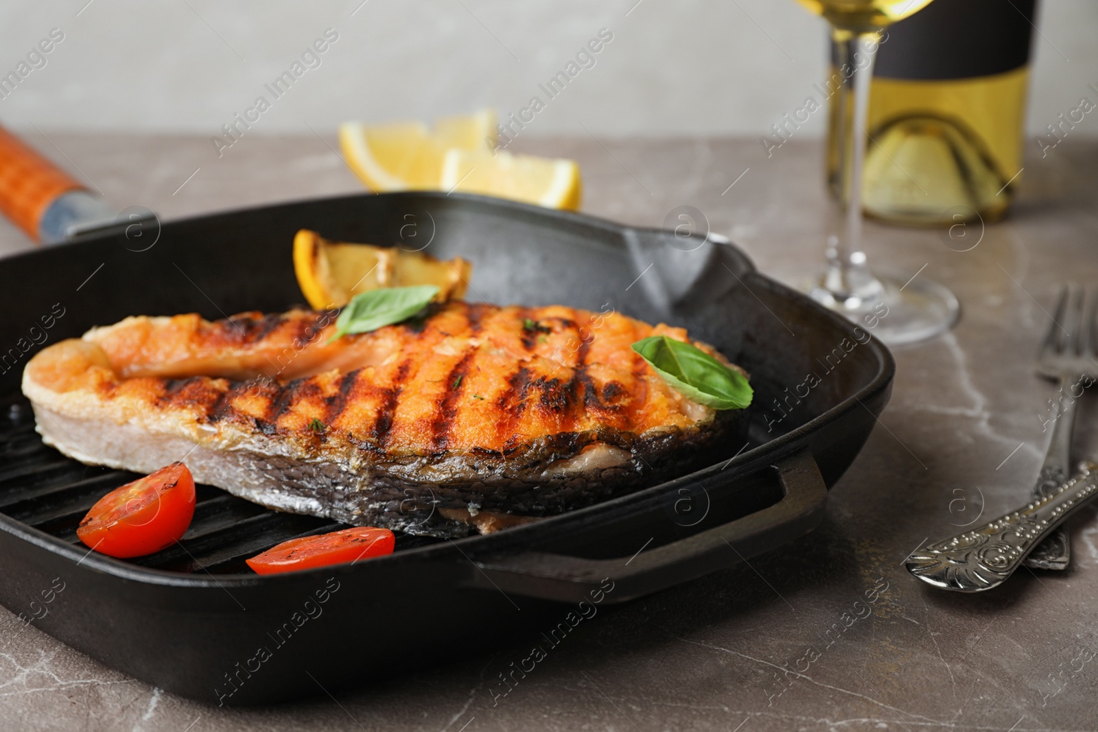 Photo of Frying pan with tasty salmon steak on table