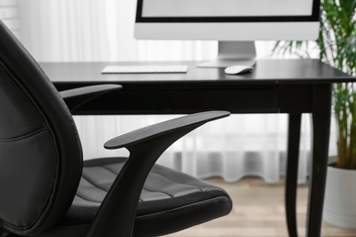 Stylish workplace interior with modern office chair