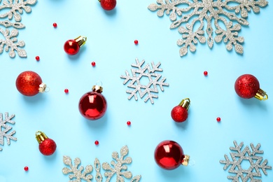 Flat lay composition with Christmas decorations on light blue background