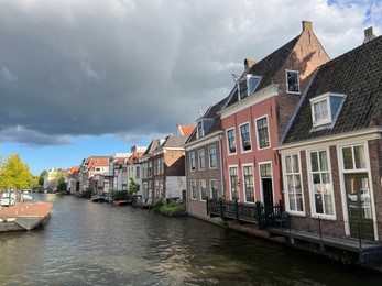 Photo of Beautiful view of buildings near canal in city under cloudy sky