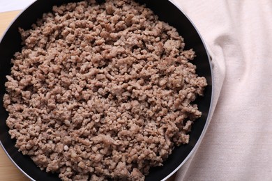 Fried minced meat in pan on table, top view