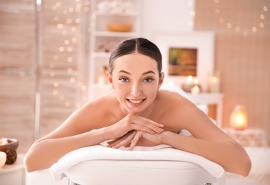 Photo of Beautiful young woman on massage table in spa salon