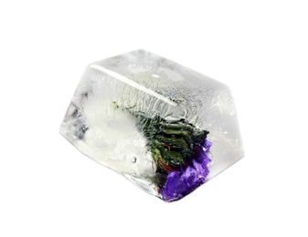 Ice cube with flower on white background