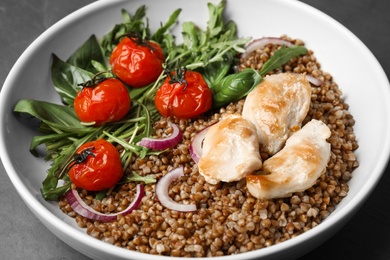 Tasty buckwheat porridge with meat and vegetables, closeup