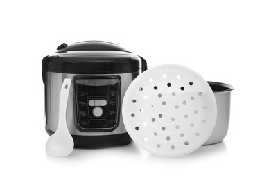 Photo of Disassembled electric multi cooker and spoon on white background