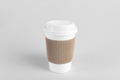 Photo of Paper cup with plastic lid on light background. Coffee to go
