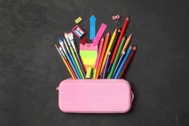 Photo of Flat lay composition with different school stationery on black stone table. Back to school