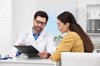 Doctor consulting patient during appointment in clinic