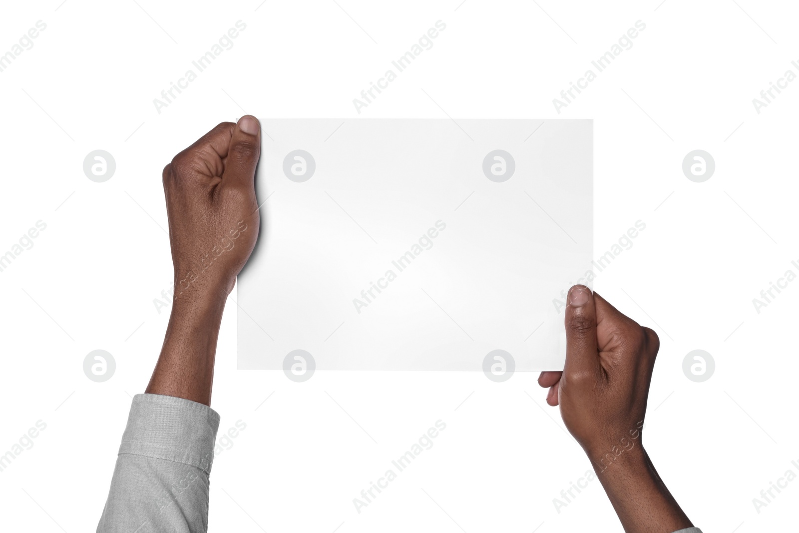 Photo of African American man holding sheet of paper on white background, closeup. Mockup for design