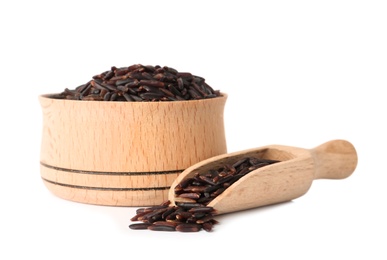 Bowl and scoop with uncooked black rice on white background