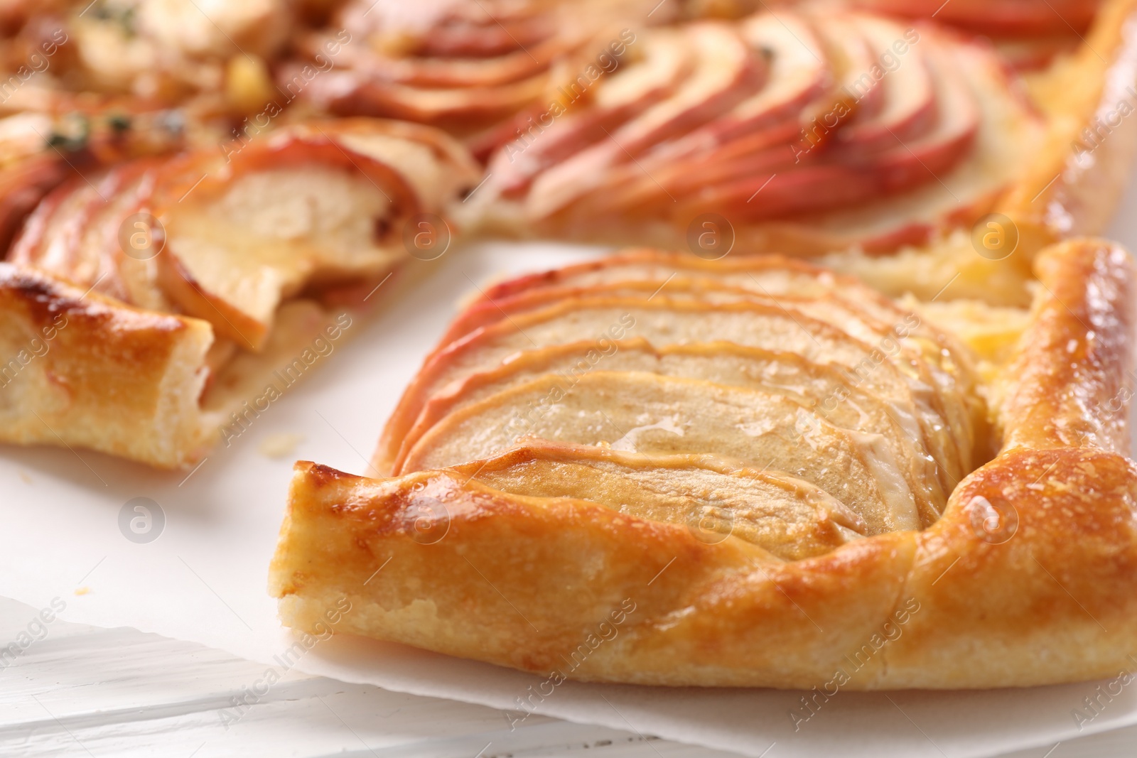 Photo of Freshly baked apple pie on white table, closeup