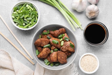 Photo of Tasty soy sauce, roasted meat and ingredients on grey table, flat lay