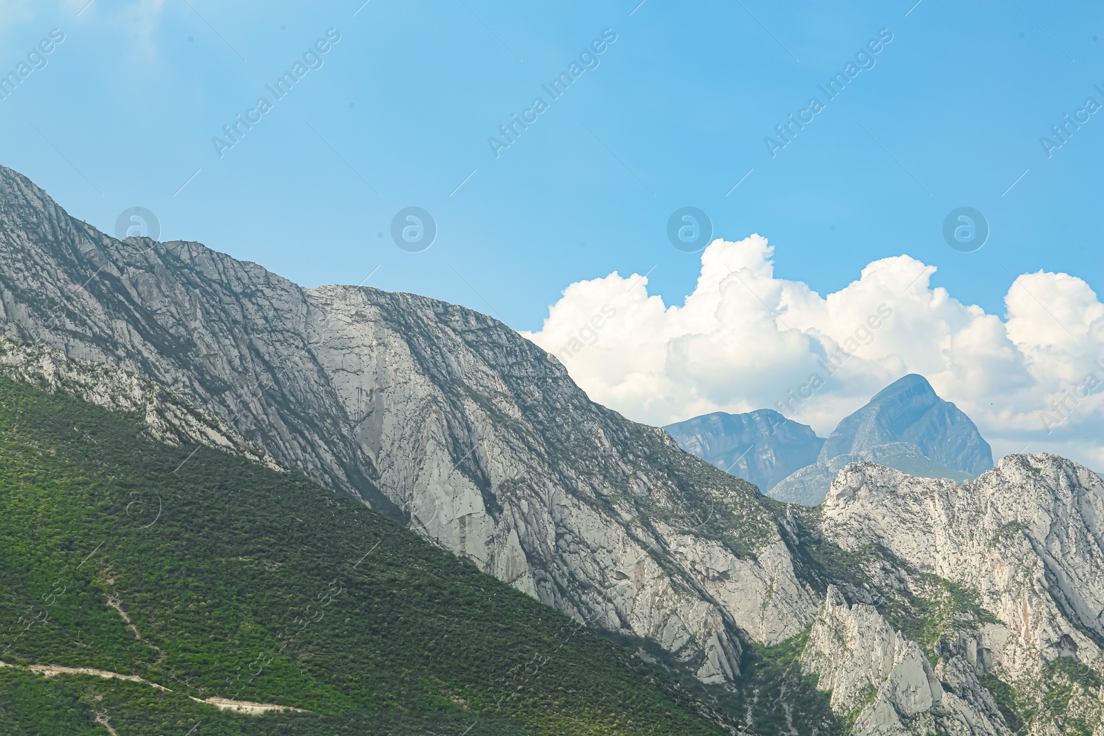 Photo of Majestic mountain landscape under blue sky with clouds