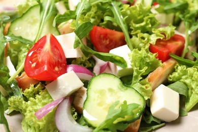 Photo of Delicious salad with meat, arugula and vegetables on plate, closeup