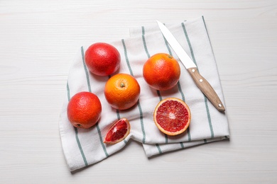 Photo of Fresh ripe red oranges on white wooden table, flat lay