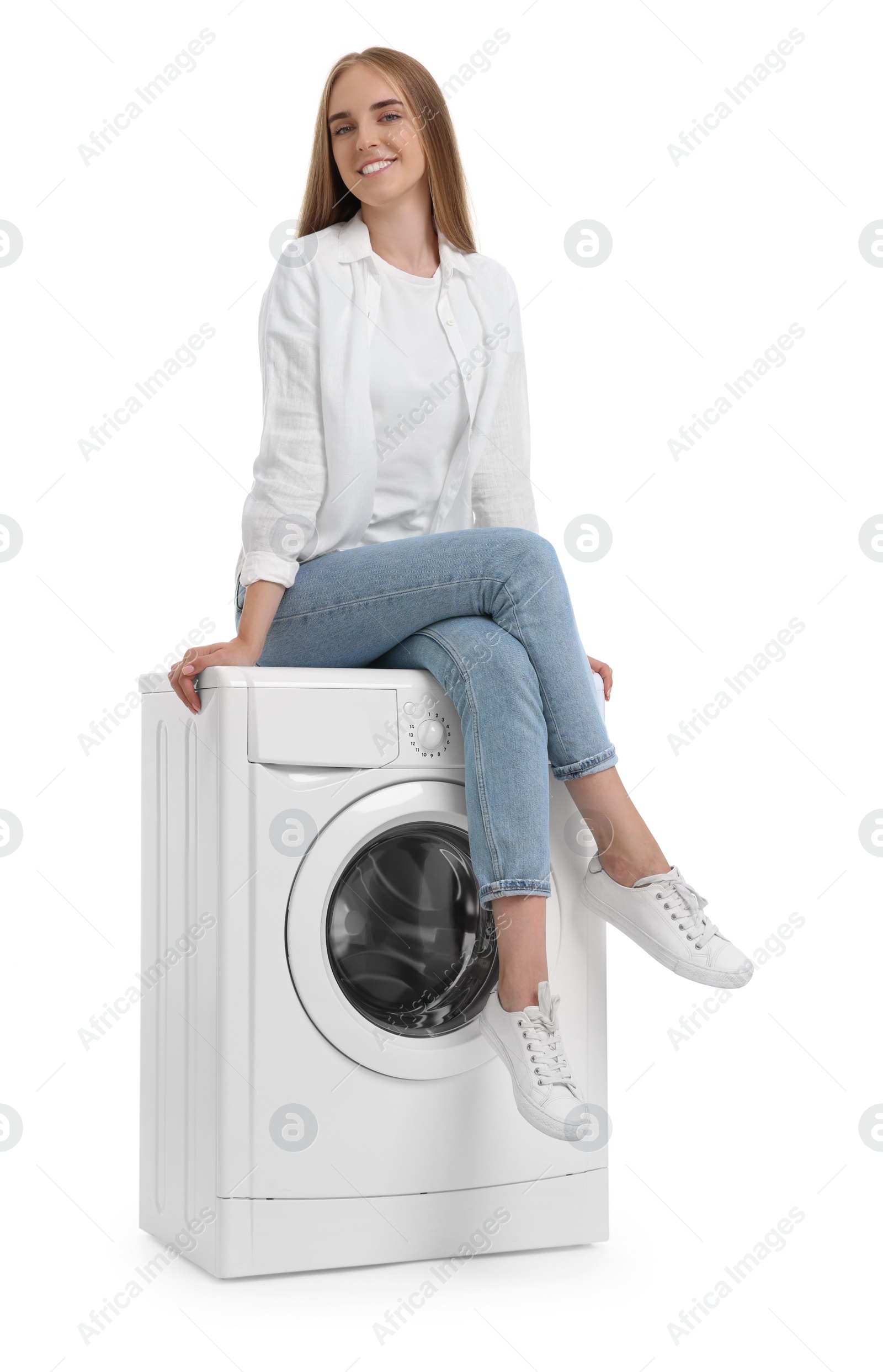 Photo of Beautiful young woman on washing machine against white background