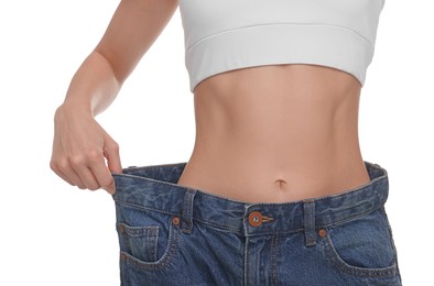 Photo of Slim woman wearing big jeans on white background, closeup. Weight loss