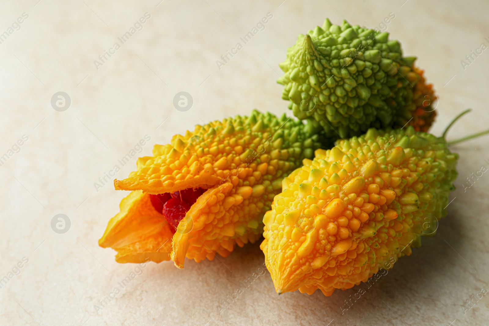 Photo of Fresh bitter melons on light table, closeup