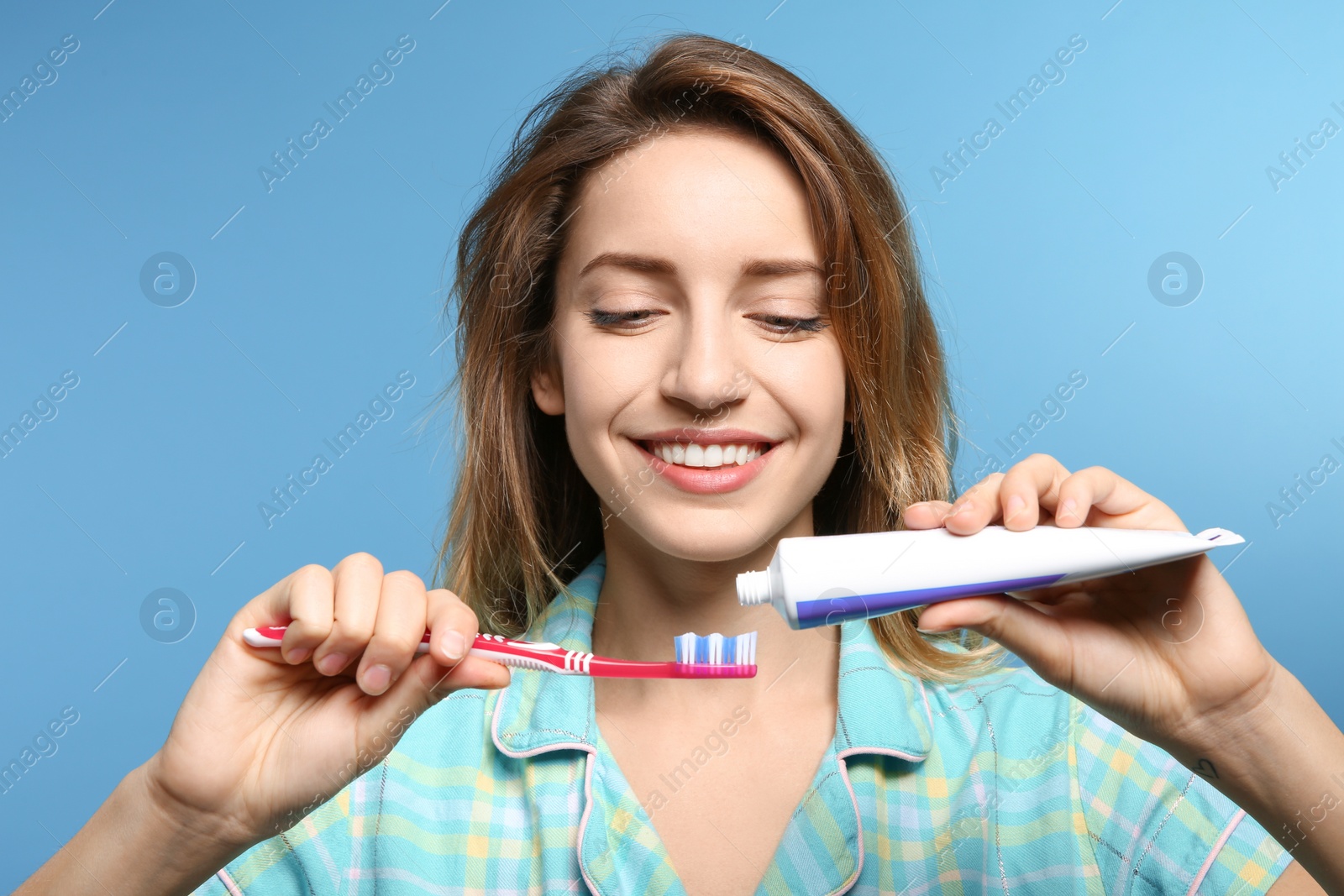 Photo of Portrait of young woman with toothbrush and paste on color background