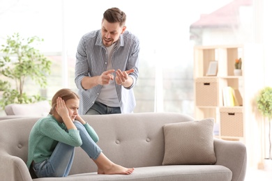 Father arguing with daughter at home