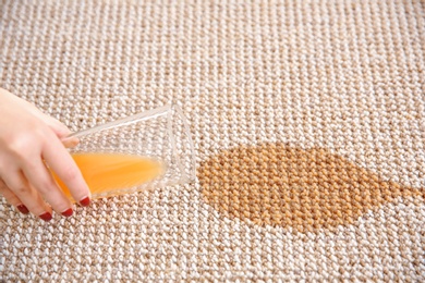 Woman spilling juice on carpet