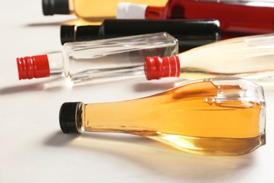 Photo of Bottles with different kinds of vinegar on light table