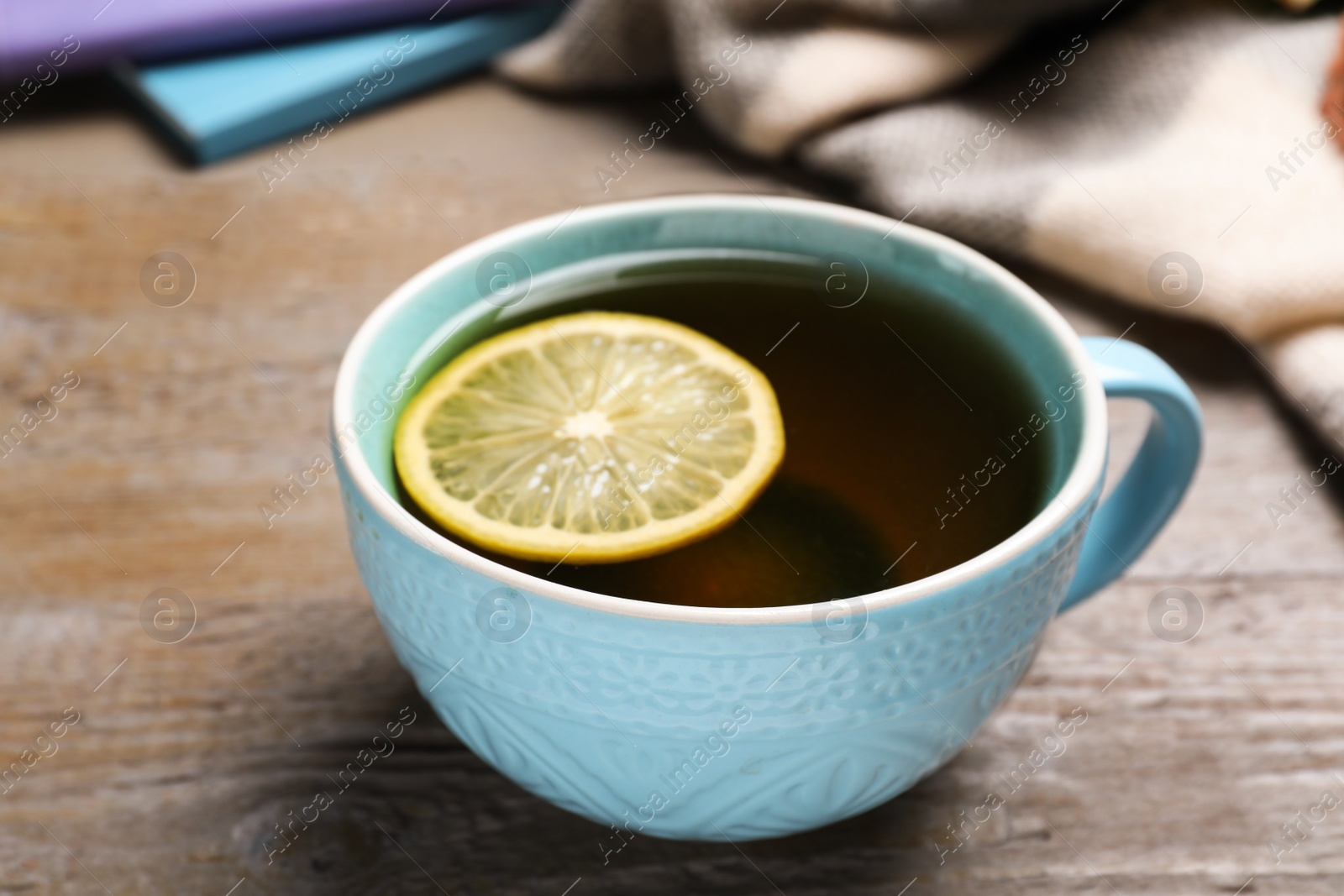 Photo of Cup of hot drink on wooden table, closeup. Cozy autumn atmosphere