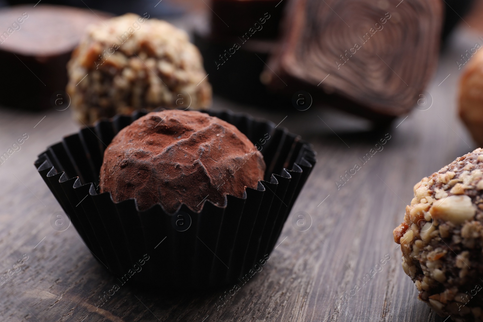 Photo of Tasty chocolate candies on table, closeup view