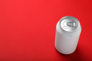 White can of energy drink on red background. Space for text