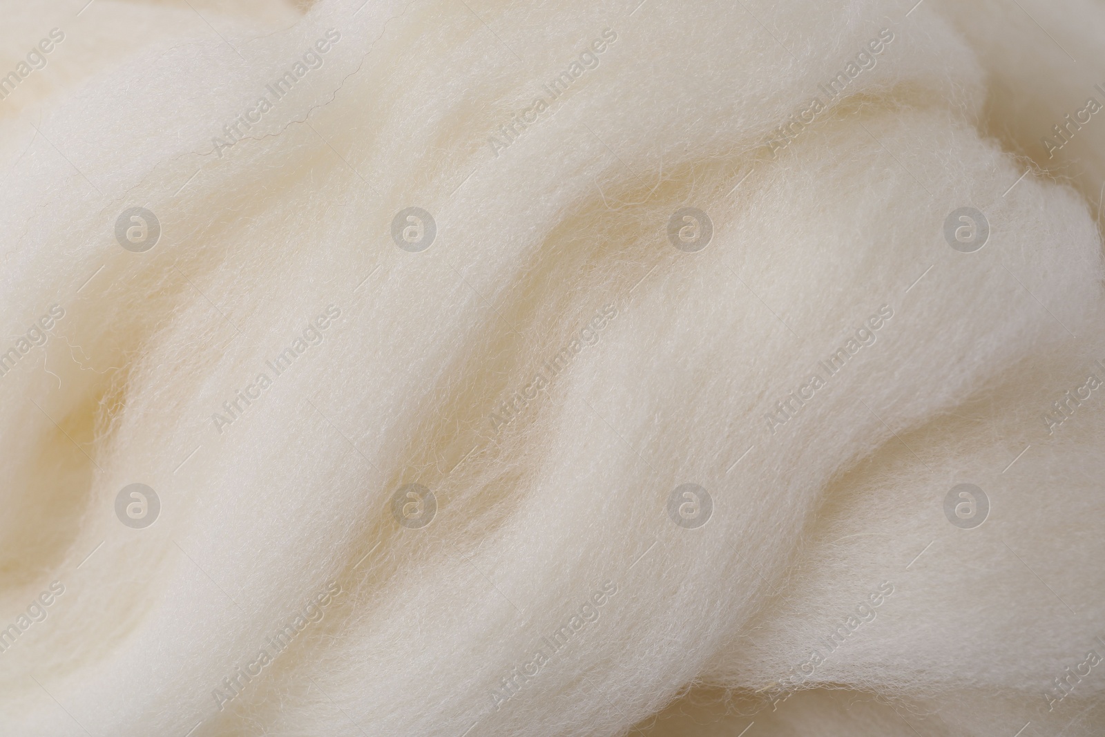 Photo of White felting wool as background, closeup view