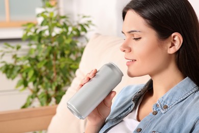 Photo of Woman drinking beverage on sofa at home