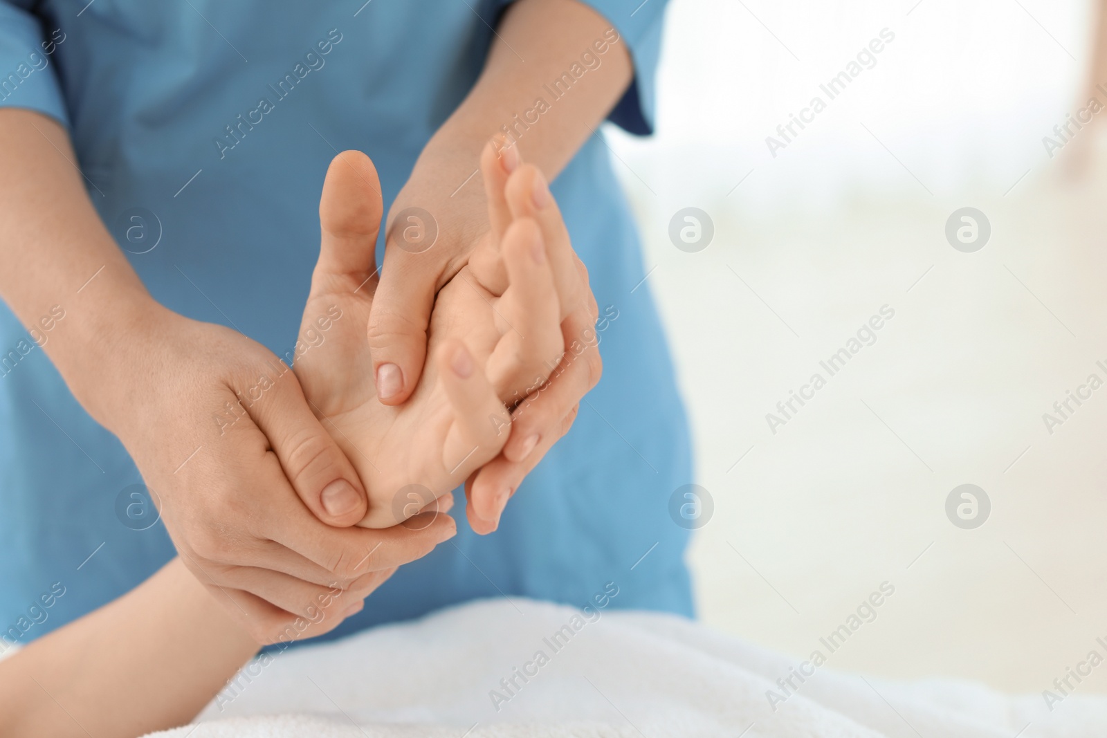 Photo of Woman receiving hand massage in wellness center, closeup