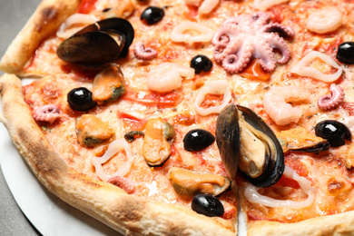 Photo of Closeup view of delicious fresh seafood pizza