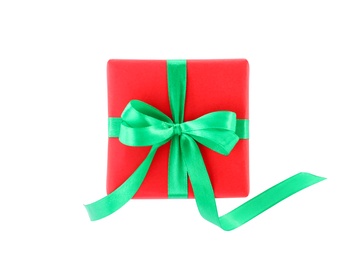 Christmas gift box decorated with ribbon bow on white background, top view