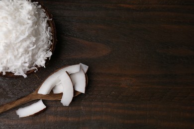 Coconut flakes, spoon and nut on wooden table, top view. Space for text