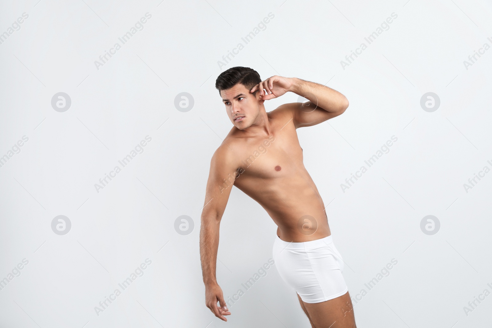 Photo of Handsome man in underwear on white background