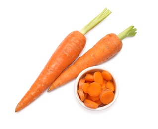 Photo of Whole and sliced ripe carrots on white background, top view