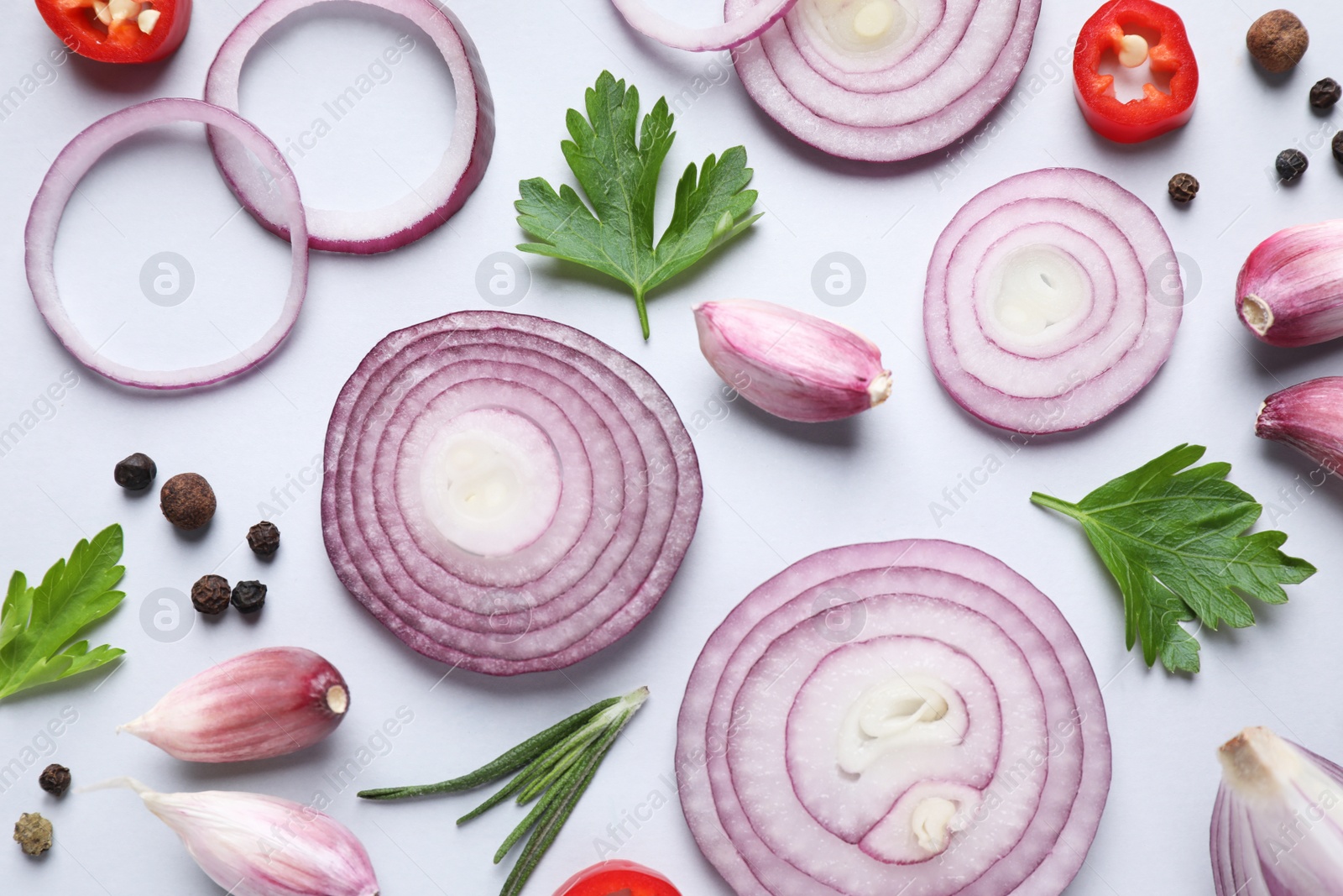 Photo of Flat lay composition with cut onion and spices on light background