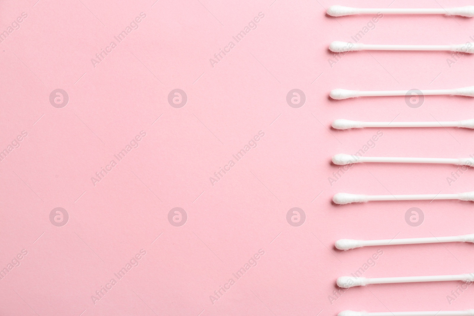 Photo of Flat lay composition with cotton swabs and space for text on color background