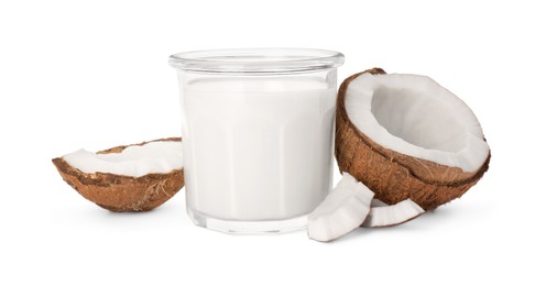 Glass of delicious vegan milk and coconut pieces on white background